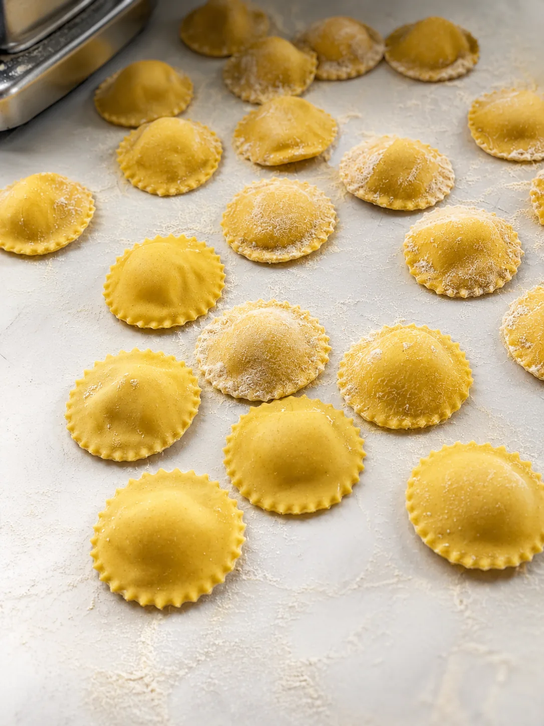 Handmade round yellow ravioli on a work surface